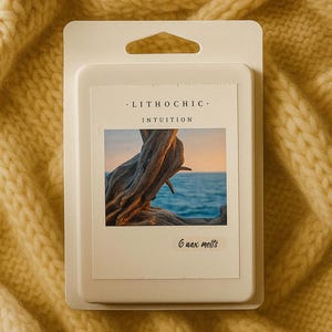 May include: A white wax melt package with the text "LITHOCHIC" and "INTUITION". The package features an image of driftwood against a seascape. The package contains 6 wax melts and is set against a yellow knitted background.