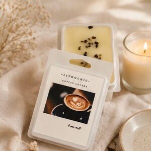 May include: A package of Lithochic Coffee Lovers wax melts with a coffee art image. The wax melts are light yellow with dark specks. A lit candle in a glass and a small ceramic dish are also in the image.