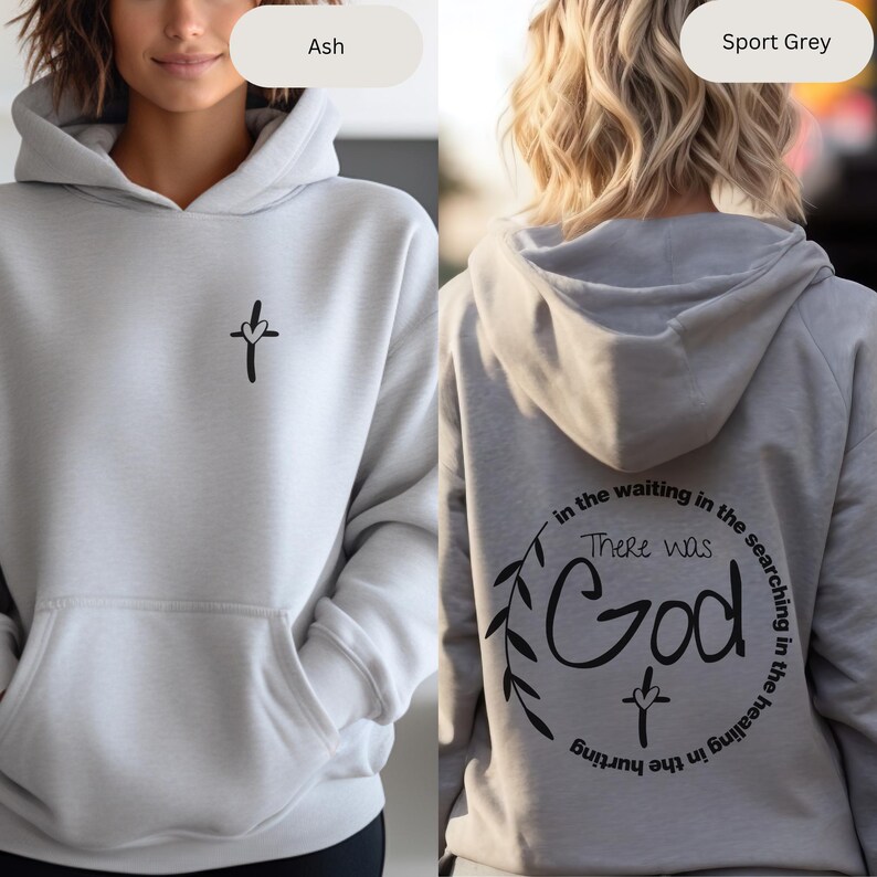 May include: A light grey hoodie with a small cross and heart design on the front. The back of the hoodie has a circular design with the words "There was God" and a cross inside a wreath of leaves.