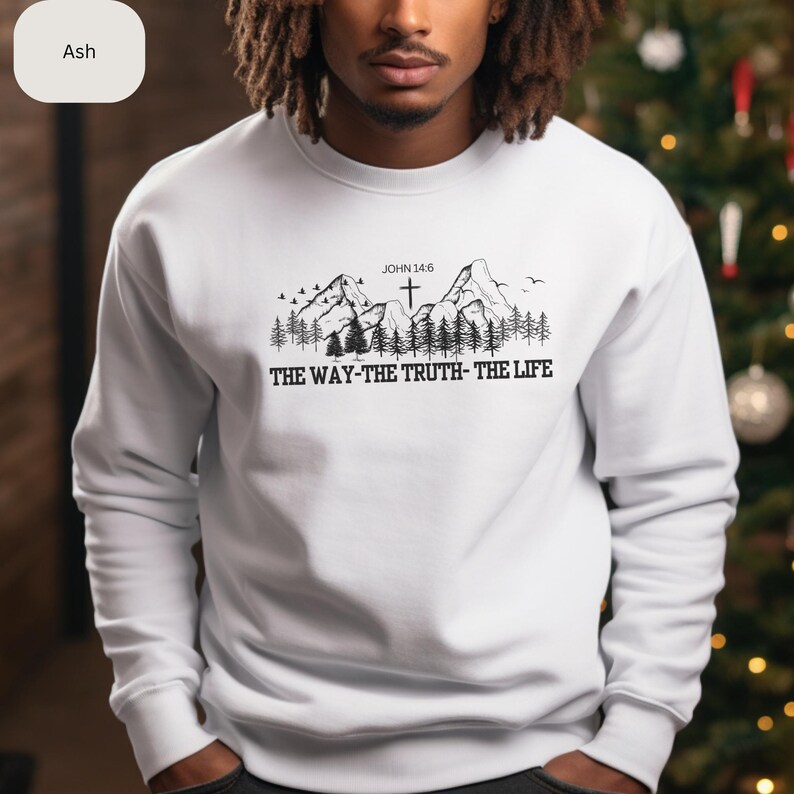 May include: White sweatshirt with a black mountain range graphic and the text "JOHN 14:6 THE WAY-THE TRUTH-THE LIFE" printed on the front.