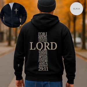 May include: Black zip-up hoodie with a cross graphic on the chest and back. The back features a cross design with the text "FOR I KNOW THE PLANS I HAVE FOR YOU DECLARES THE LORD PLANS TO PROSPER AND NOT TO HARM YOU PLANS TO GIVE YOU HOPE FUTURE AND A JEREMIAH 29:11."