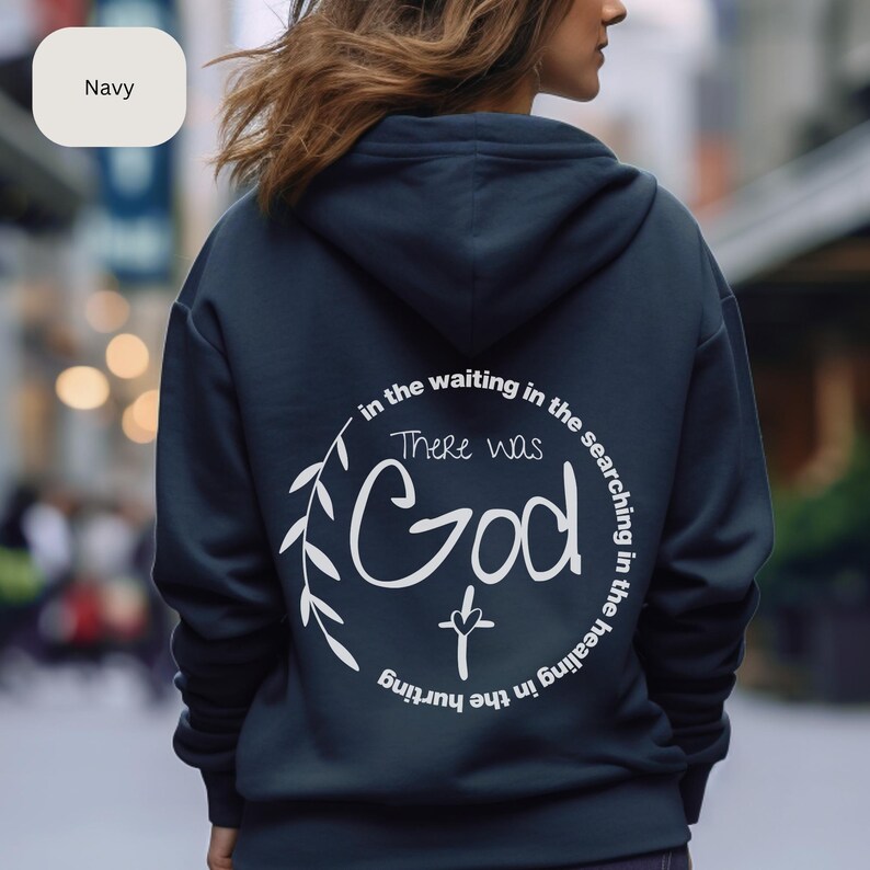 May include: Navy blue hoodie with a white graphic print that says "in the waiting in the searching in the healing in the hurting there was God" with a cross underneath the word God.