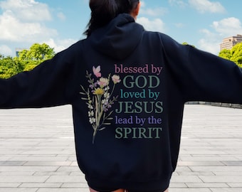 May include: Black hoodie with a floral design and the text "blessed by GOD loved by JESUS lead by the SPIRIT" printed on the back.