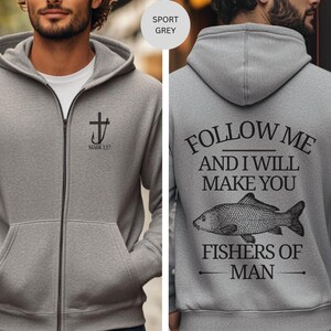May include: Sport grey zip-up hoodie with a black cross and hook design, and the text "MARK 1:17" on the front. The back features the text "FOLLOW ME AND I WILL MAKE YOU FISHERS OF MAN" with a fish illustration.