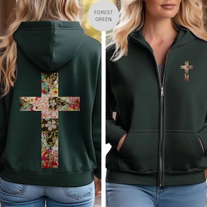 May include: Forest green zip-up hoodie with a floral cross design on the back and a smaller floral cross on the front. The hoodie has a hood, pockets, and a full-length zipper. The floral cross features a mix of red, white, and yellow flowers.