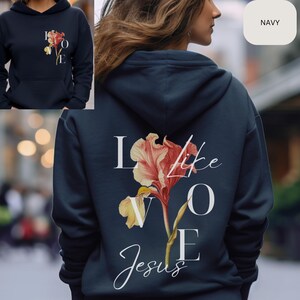 May include: Navy blue hoodie with a white graphic of a flower and the text "Love like Jesus".