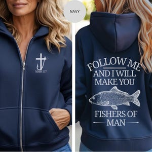 May include: Navy blue zip-up hoodie with a white cross and hook design, and the text "MARK 1:17" on the front. The back features the text "FOLLOW ME AND I WILL MAKE YOU FISHERS OF MAN" with a fish graphic.