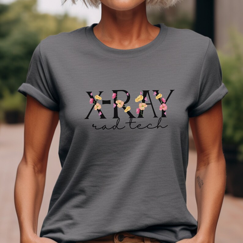 May include: A gray t-shirt with the text "X-RAY rad tech" in black lettering with floral accents.