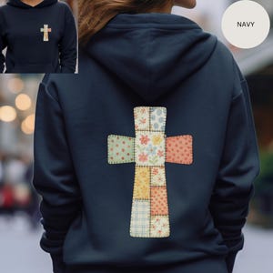 May include: Navy blue hoodie with a patchwork cross design on the back. The cross is made of various fabric squares with floral, polka dot, and plaid patterns. A smaller cross is on the front. The word "NAVY" is in a circle.