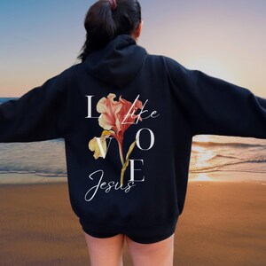 May include: Black hoodie with a floral design and the text "Love like Jesus" printed on the back.