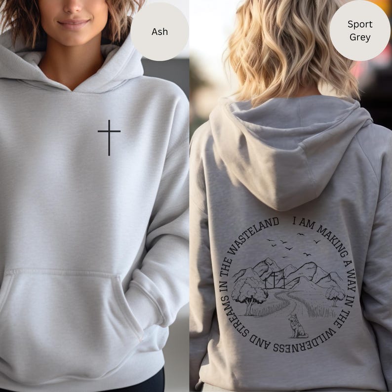 May include: A gray hoodie with a cross on the front and a graphic on the back that says "I am making a way in the wilderness and streams in the wasteland".