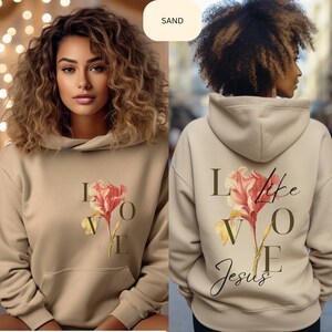 May include: A beige hoodie with a floral design and the text "Love like Jesus" printed on the front and back.