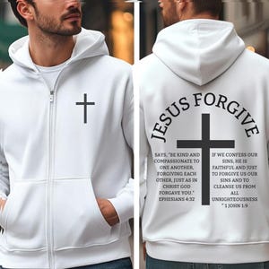 May include: White zip-up hoodie with a black cross on the front and a larger cross on the back. The back of the hoodie has the words "JESUS FORGIVE" and Bible verses printed in black. Features a hood and front pockets.