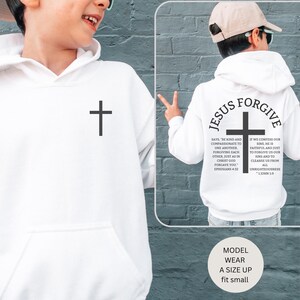 May include: White hooded sweatshirt with a black cross on the front and the words "JESUS FORGIVE" and related text on the back. The sweatshirt also has the text "MODEL WEAR A SIZE UP fit small".
