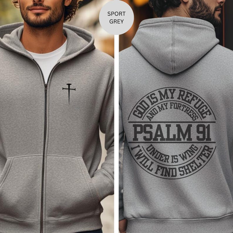 May include: A gray zippered hoodie with a cross on the front and the text "God is my refuge and my fortress Psalm 91 I will find shelter under his wing" on the back.