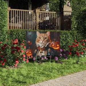 May include: A Halloween-themed yard sign featuring a cartoon orange cat wearing a blue and gold costume with a bell around its neck. The cat is surrounded by jack-o'-lantern pumpkins.