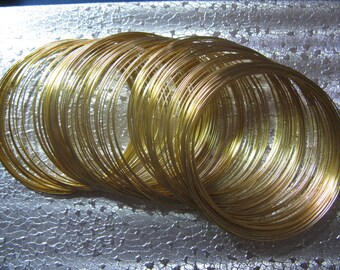 May include: A pile of gold-colored wire rings, likely for jewelry making or crafting.