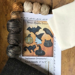 May include: A punch needle kit for making Halloween ornaments. The kit includes a variety of coloured embroidery floss, a piece of fabric, and a pattern for making a bat, a pumpkin, a witch, a cat, and a crow. The pattern is titled "Halloween Ornaments" and includes the text "Punch Needle 3" to 5" TPT PN262".