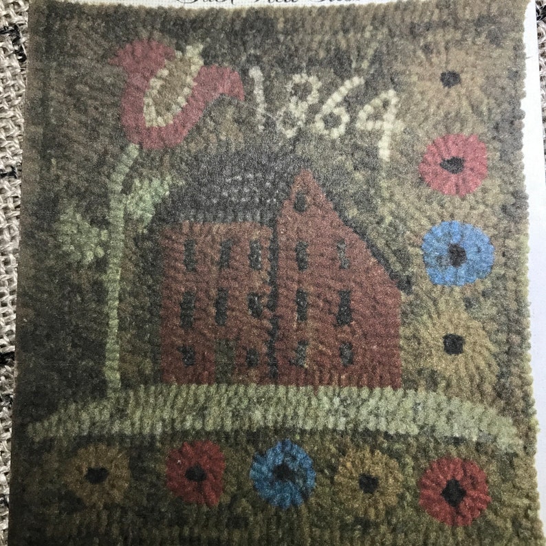 May include: A vintage-style rug with a red house, a large pink flower, and the year "1864" stitched into the design. The rug features a brown, green, and tan color palette with small floral accents.