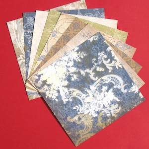 Pode incluir: Um conjunto de 10 folhas de papel de scrapbooking com padrões em vários tons de azul, verde, marrom e branco. O papel apresenta uma variedade de desenhos florais e paisley.