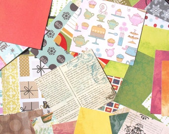 May include: A collection of colorful patterned paper scraps, including a sheet with a teacup and cake design, a sheet with a newspaper print, and a sheet with a polka dot pattern.