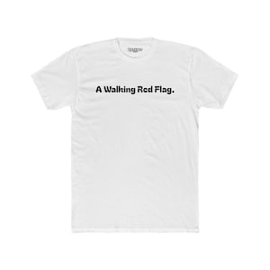 May include: White t-shirt with black text that reads "A Walking Red Flag."
