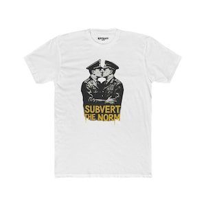 May include: White t-shirt featuring a black and white illustration of two men in military uniform kissing. The text "Subvert the Norm" is written in yellow below the image.