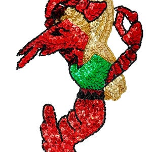 May include: A sequined crab applique in red, gold, and green. The crab's body is gold, with red claws and legs. The crab's belly is green. The edges are outlined with black beads. This decorative applique is perfect for embellishing clothing or accessories.