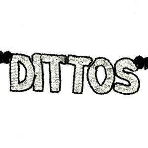 May include: A white sequined patch with the word "DITTOS" in silver sequins outlined in black. Small black beaded accents are on each side of the word, against a white background.