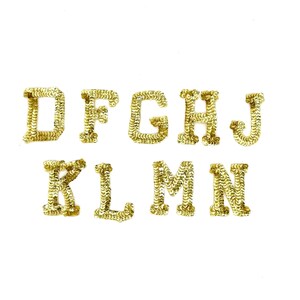 May include: Gold sequin letters D, F, G, H, J, K, L, M, and N are displayed against a white background. The letters are in a serif font and appear to be individual embellishments for crafts or decor.