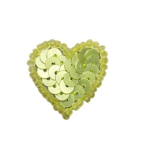 May include: A heart-shaped embellishment with a light green color. The heart is made of round sequins and small beads, all in shades of green. The sequins are arranged in a pattern, and the beads outline the heart.