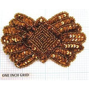 May include: A gold sequined applique with a diamond shape in the center. The applique is approximately 3 inches wide and 2 inches tall.
