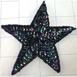May include: A five-pointed star-shaped patch covered in iridescent dark green and purple sequins. The edges of the star are outlined with a border of small, dark, metallic-toned beads, creating a textured finish on the surface of the applique.