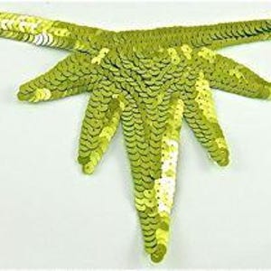 May include: A lime green sequined applique in the shape of a stylized flower with five petals.