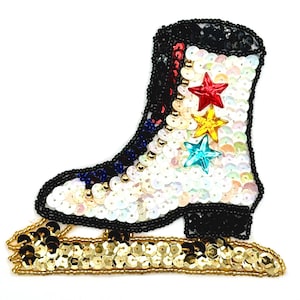 May include: A white, black and gold sequined ice skate applique with red, yellow and blue star embellishments.