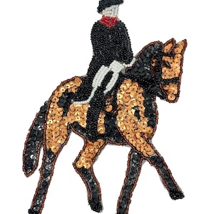 May include: A decorative patch featuring a rider on horseback, crafted with black and copper-colored sequins and beads. The rider wears a black jacket with a red collar, while the horse displays a patterned coat of black and copper sequins.