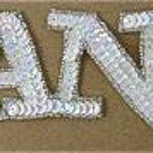 May include: White sequined iron-on patch that says "DANCE" in a cursive font.