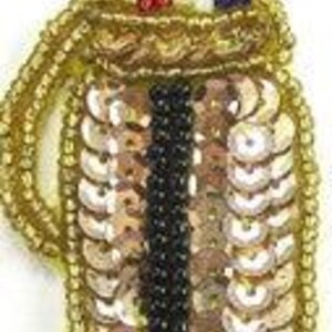 May include: A gold sequined golf bag with a red, white, and blue beaded golf club on top.