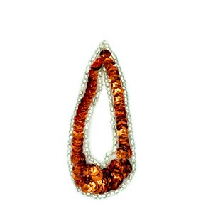 May include: A teardrop-shaped embellishment with a silver beaded border and filled with orange sequins. The sequins are arranged in a pattern, creating a textured surface. The design is set against a white background.
