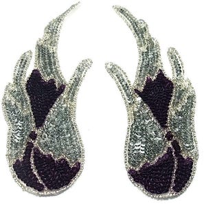 May include: Two decorative appliques in a flame design. The appliques feature silver sequins outlining a dark purple sequined center. The edges are trimmed with small silver beads. The appliques are set against a white background.