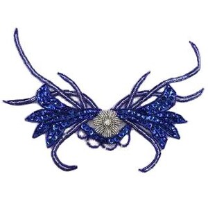 May include: A blue beaded applique with a central silver flower design. The applique features intricate detailing with curved, linear elements and a symmetrical butterfly-like shape. The design is embellished with sequins and beads.