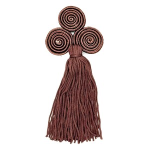 May include: A decorative tassel in a rich brown hue, featuring three spiral-shaped accents at the top. The tassel is made of numerous strands, creating a full, textured appearance. The design is set against a clean white background.