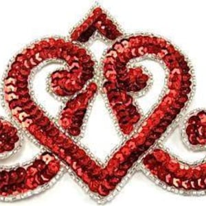 May include: A red sequined heart-shaped applique with a silver border. The design features two intertwined heart shapes and a small crown detail at the top. The sequins are densely packed, creating a shimmering effect.