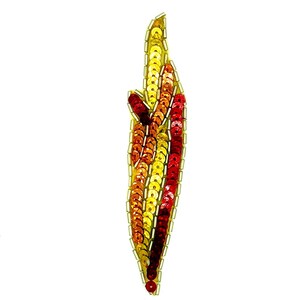 May include: A decorative sequin applique in a flame shape. The sequins are in shades of yellow, orange, and red, outlined with gold thread. The applique is on a white background.