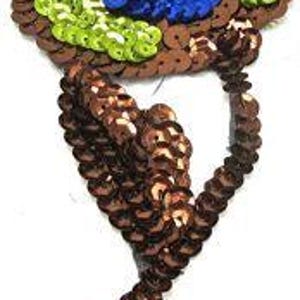May include: A brown, green, and blue sequined flower applique. The flower has a round center with blue sequins and a brown stem with green sequins.