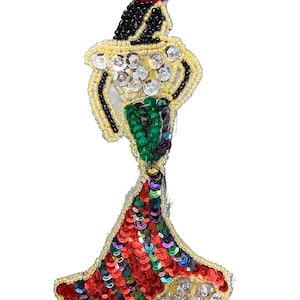 May include: A decorative patch featuring a stylized figure in a long gown, crafted with red, green, and silver sequins, black beads for the hair, and a red beaded headpiece, all outlined with yellow seed beads on a sheer mesh backing.