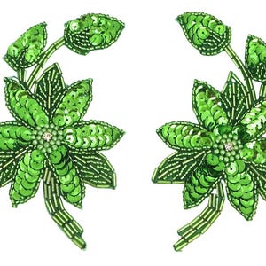 May include: A pair of bright green floral appliques featuring intricate beadwork and sequins. Each piece displays a central flower with radiating petals, accented by smaller leaves and stems, all crafted with shimmering green beads and sequins.