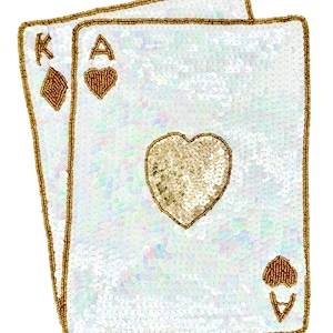 May include: A decorative patch featuring two overlapping playing cards, the King of Diamonds and the Ace of Hearts, crafted with iridescent white sequins and gold beaded edges. The central heart and card symbols are filled with gold sequins and beads.
