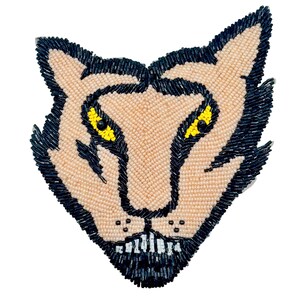 May include: A beaded applique in the shape of a wolf's head. The wolf's face is tan, with black outlines and details. The eyes are yellow. The applique is made of small beads and is likely for clothing or accessories.