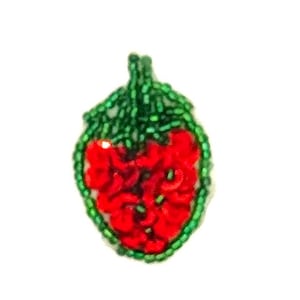 May include: A strawberry-shaped patch crafted from vibrant red and green beads. The central body of the fruit is composed of textured red beads, while the top stem and the outer border are defined by small, bright green beads in a detailed pattern.